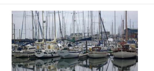 a bunch of boats are docked in a harbor at Amble Holiday Home in Amble
