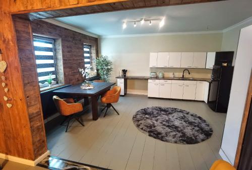 a kitchen with a table and a dining room at Apart Oderblick in Neubleyen