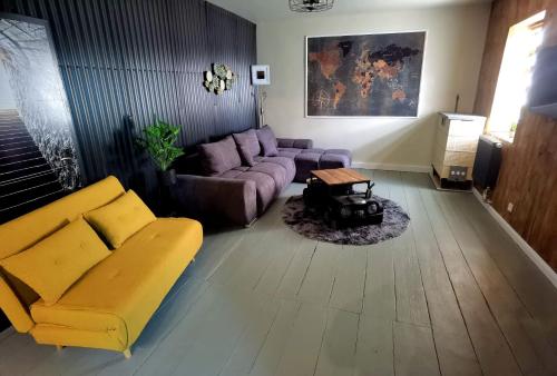 a living room with a couch and a table at Apart Oderblick in Neubleyen