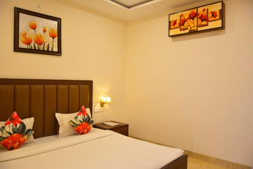 a bedroom with a bed with flowers on it at SERENE SUITES in Dharamshala