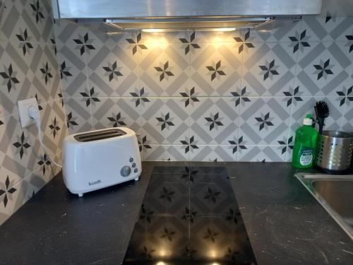 a toaster sitting on a counter in a kitchen at Lopes Apartment - Belch1952 in Lagos