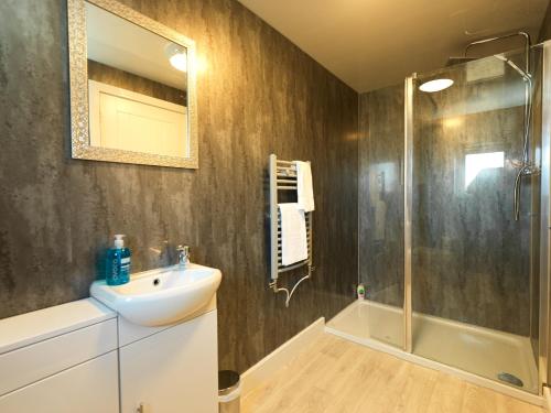 a bathroom with a sink and a shower at Shrewsbury Townhouse with Parking in Harlescott