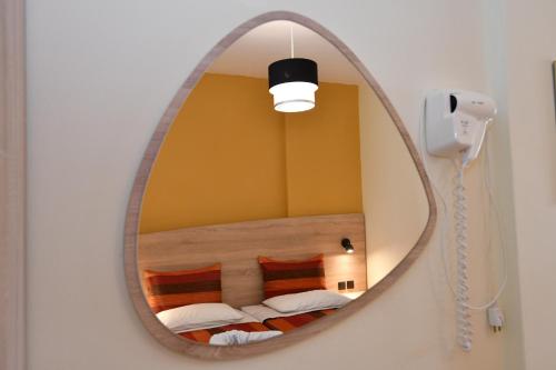 a mirror in a room with a bed and a phone at Iskas apartments in Ialysos