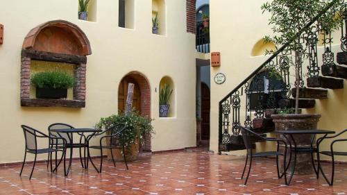a patio with chairs and tables in a building at Hotel Casa Tequis San Luis Potosi in San Luis Potosí