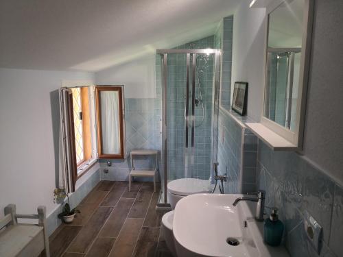 a bathroom with two toilets and a sink and a shower at Il Montedoro in Guardistallo