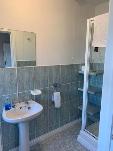 a bathroom with a sink and a shower at Millfield Holiday Village in Portstewart