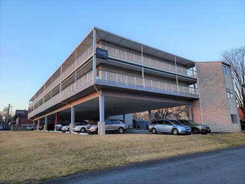 a building with cars parked in a parking lot at Escape Inn Hershey in Hershey