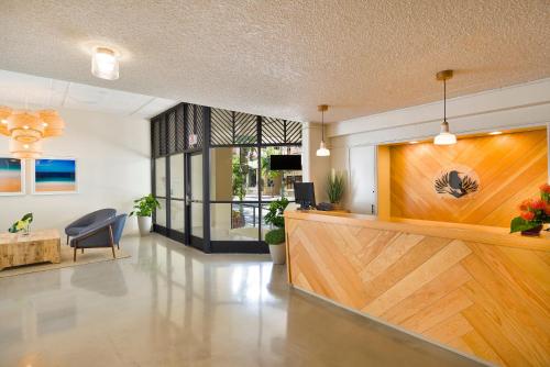 a lobby with a reception desk in a building at Ohia Waikiki Studio Suites in Honolulu