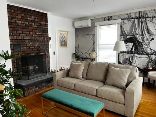 a living room with a couch and a fireplace at Queen Anne's Revenge in Bar Harbor