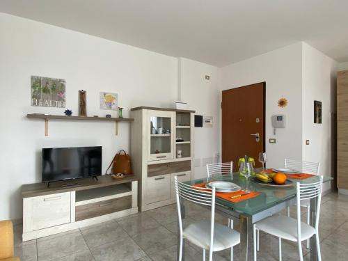jadalnia ze stołem, krzesłami i telewizorem w obiekcie appartamento w mieście Porto Torres