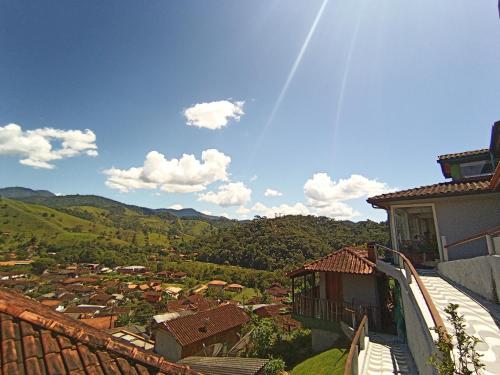 a view of a town from the balcony of a house at Pousada Da Santina in Visconde De Maua