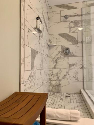 a bathroom with a shower with a marble wall at Pinecrest Bed & Breakfast in Asheville