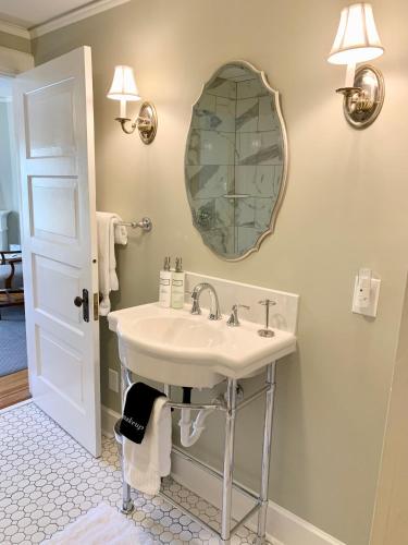 a bathroom with a sink and a mirror at Pinecrest Bed & Breakfast in Asheville
