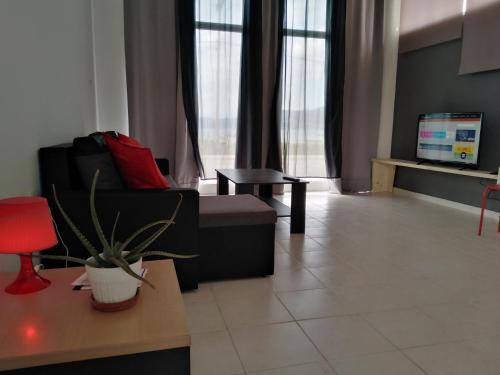 a living room with a couch and a table at STUDIOS POSEIDONIA apartments 50 & 70 sqm with sea view in Korinthos