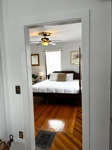 a bedroom with a bed and a ceiling fan at Queen Anne's Revenge in Bar Harbor