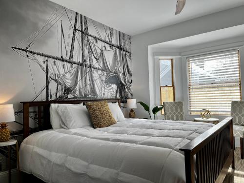 a bedroom with a large bed with a sail on it at Queen Anne's Revenge in Bar Harbor