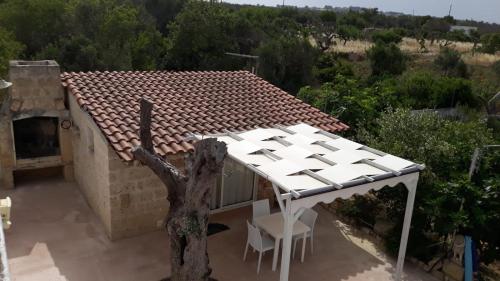 a view of a house with a white roof at Giardino dei Baroni house in Marina di Mancaversa