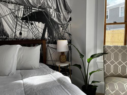 a bedroom with a bed and a lamp and a plant at Queen Anne's Revenge in Bar Harbor