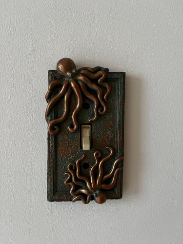 a brown switch with an octopus on a wall at Queen Anne's Revenge in Bar Harbor