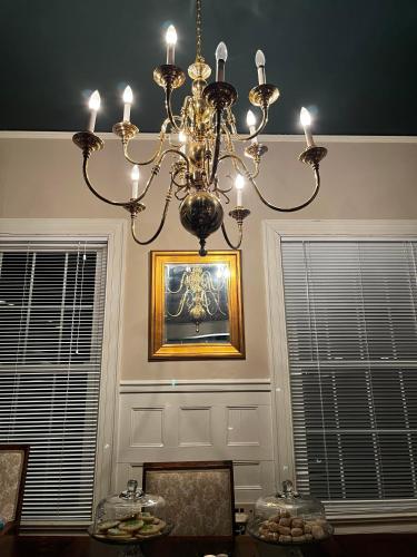 a chandelier in a dining room with a picture on the wall at Queen Anne's Revenge in Bar Harbor