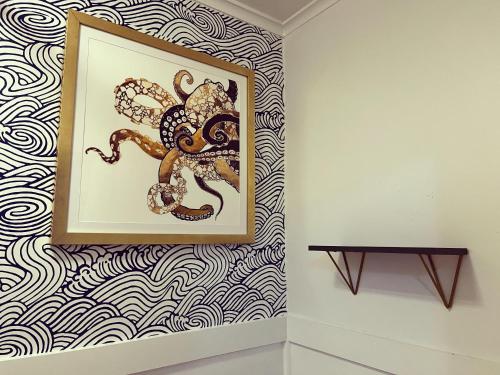 a painting of an octopus on a wall at Queen Anne's Revenge in Bar Harbor