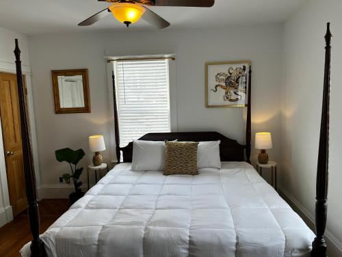 a bedroom with a large bed with a ceiling fan at Queen Anne's Revenge in Bar Harbor