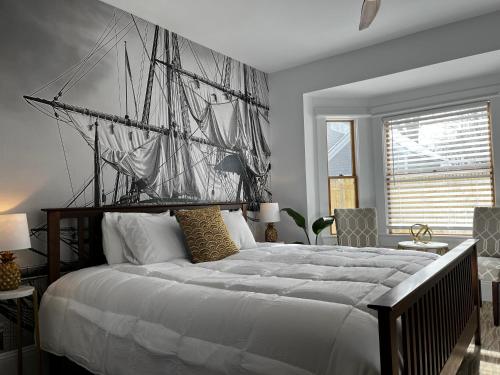 a bedroom with a large bed with a sail on it at Queen Anne's Revenge in Bar Harbor