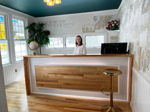a woman standing behind a counter in a room at Queen Anne's Revenge in Bar Harbor