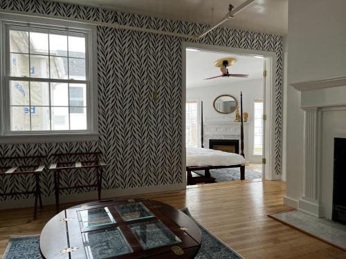 a living room with a bed and a mirror at Queen Anne's Revenge in Bar Harbor