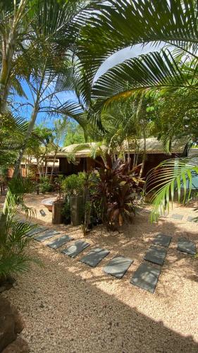 a garden with stepping stones in front of a building at LA CASE BOIS CRÉOLE in Albion