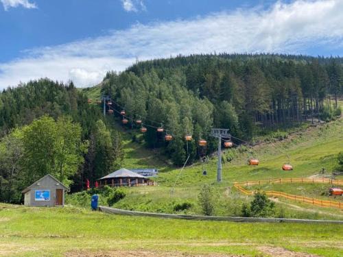 a ski slope with a gondola on a hill at Apartmán Rezidence Moser-free parking garage in Karlovy Vary