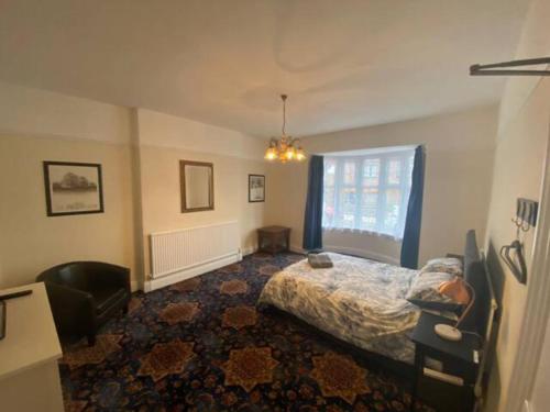 a bedroom with a bed and a window at 8 Bedroom House For Corporate Stays in Kettering in Kettering