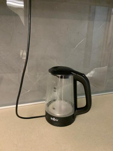 a black blender sitting on a counter with a cord at Aleksinac in Aleksinac