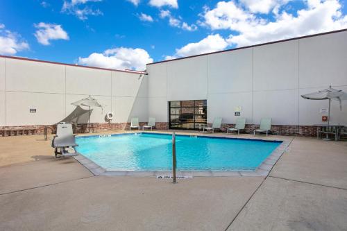 a large swimming pool in a large building at Aggieland Boutique Hotel in College Station