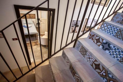 a set of stairs with a view of a bedroom at SI-Moutique Le Case degli Avi barocche, con terrazza panoramica in Modica