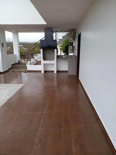 a living room with a wood floor and a stove at Sumaq House offer a new suite in Puerto Ayora