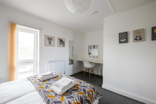 a white bedroom with a bed and a desk at Stanley Sparkle Stays - 4BRooms, 4Beds, Prkg, Wifi in Liverpool