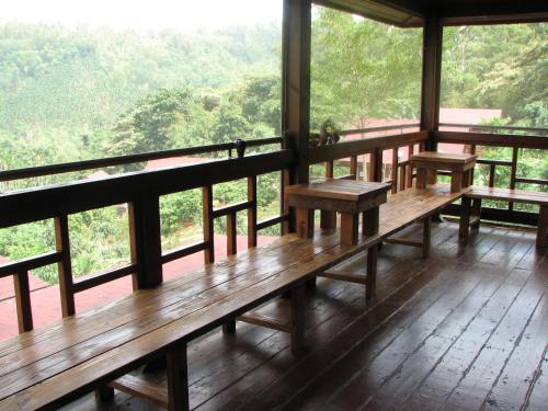 a porch with benches and a view of the forest at Ji Ji Farm Homestay in Jiji