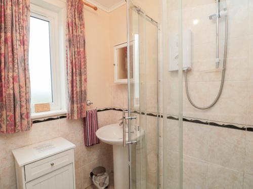 a bathroom with a shower and a sink at Bunty's Place in Chatton