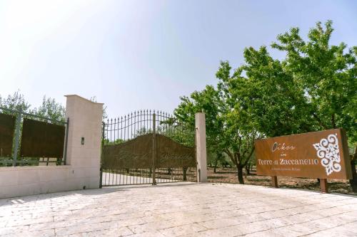 a gate with a sign in front of a building at Oikos in Terre di Zaccanello in Racalmuto