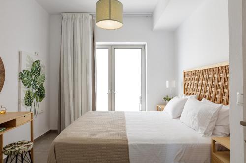 a bedroom with a large bed and a window at Aelia Seascape Apartments in Plakias