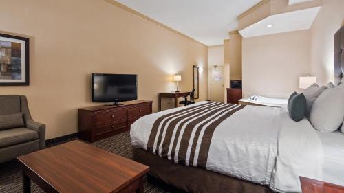a hotel room with a bed and a flat screen tv at Best Western Brantford Hotel and Conference Centre in Brantford