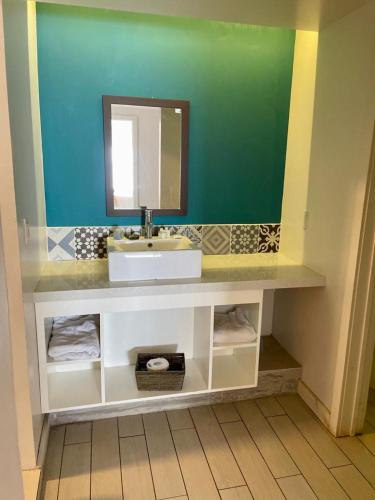 a bathroom with a sink and a mirror at Castillos Del Mar in Rosarito