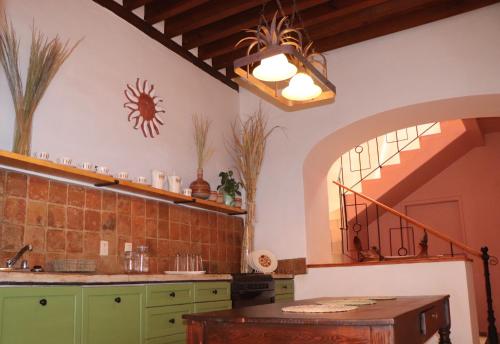 a kitchen with a sink and a table in a room at CASA DAMIANA in Lagos de Moreno