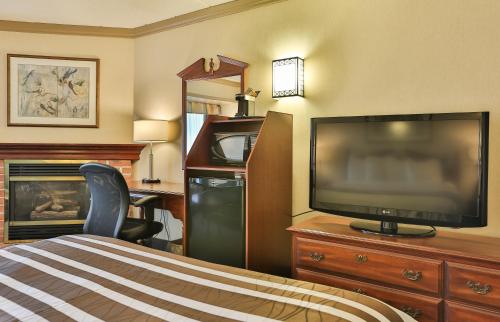 a hotel room with a bed and a flat screen tv at Best Western Brantford Hotel and Conference Centre in Brantford
