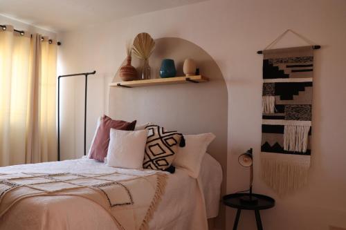 a bedroom with a bed with pillows on it at CASA DAMIANA in Lagos de Moreno