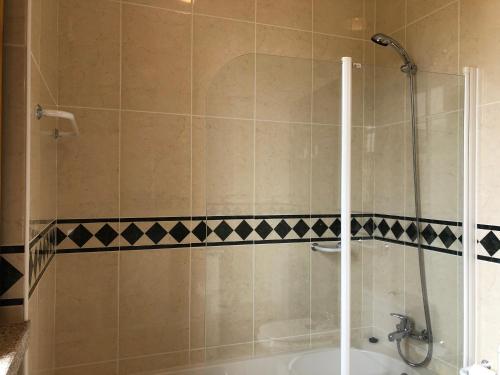 a bathroom with a shower with a tub and a sink at Casa das Eiras in Tondela