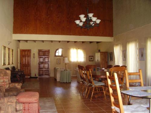 a living room with a table and chairs at Teresinajamaica in Saint Annʼs Bay