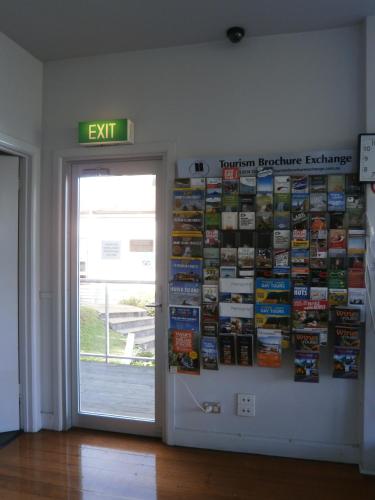 an exit sign on a wall next to a door at Waterfront Lodge Motel in Hobart