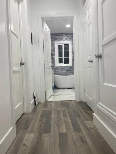 a hallway of a bathroom with a bath tub at Blanquitas Home in Long Beach